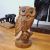 Figure wood owl sitting on branch