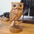 Figure wood owl sitting on branch